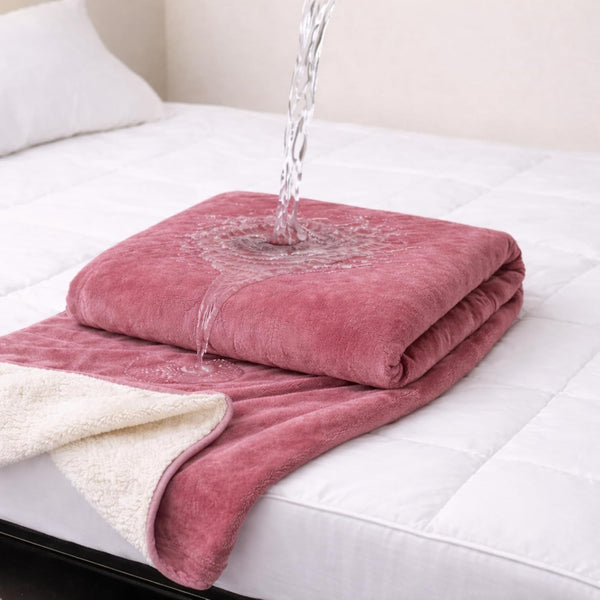 Waterproof play blanket on a bed
