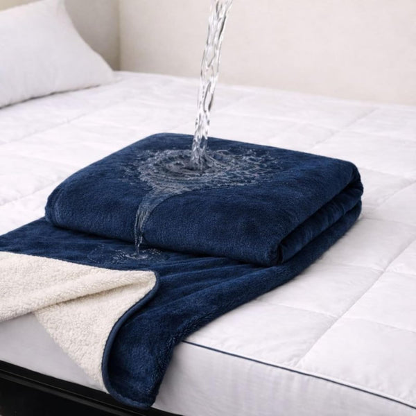 Waterproof play blanket on a bed