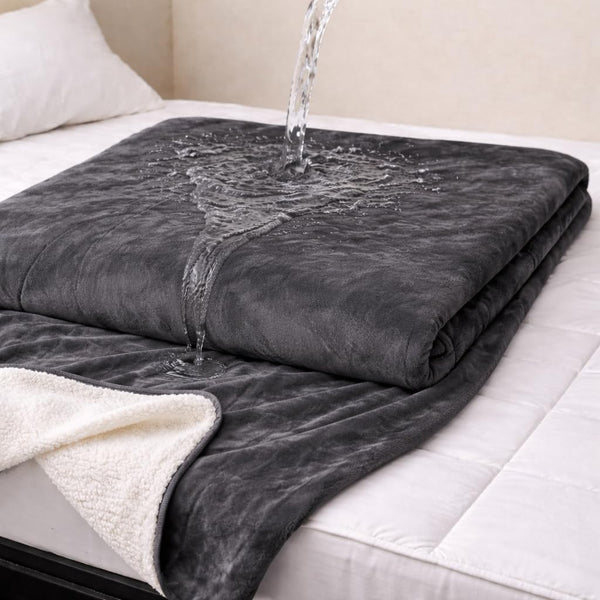 Waterproof play blanket on a bed